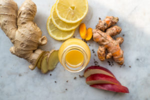 Orange and lemon ginger shot in a small glas bottle